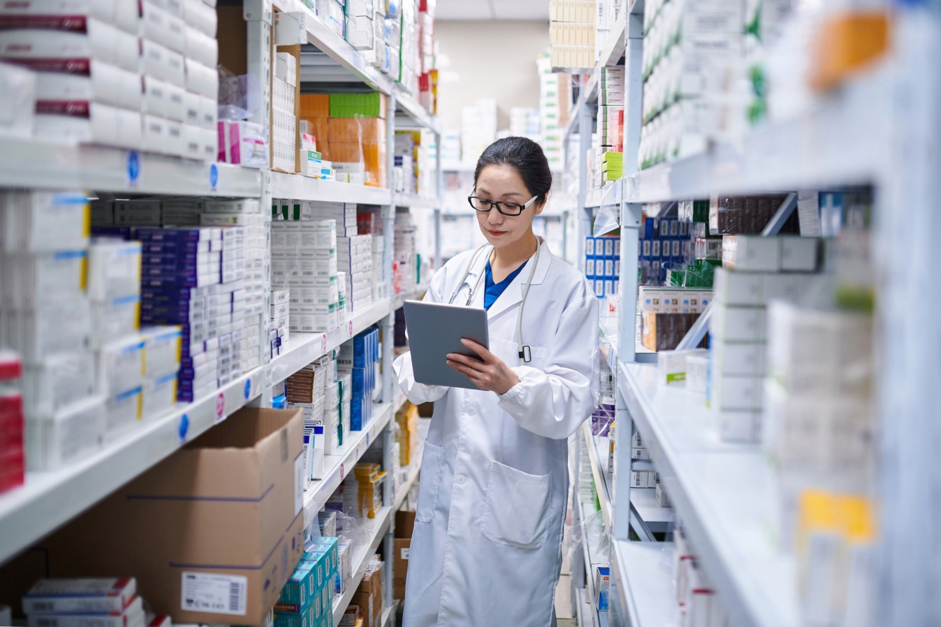 Woman cataloging medical supplies. 