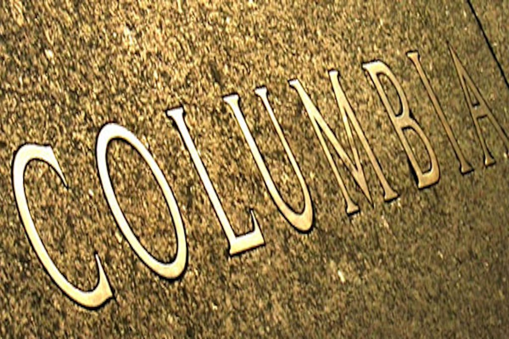 Closeup of a Columbia inscription on a campus sidewalk