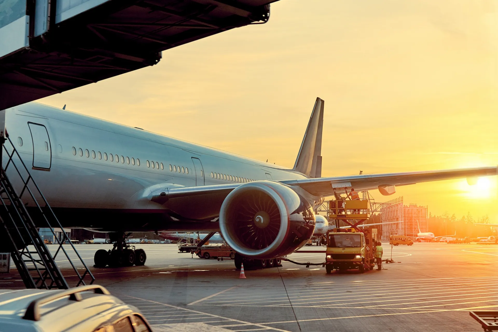 Airplane on the tarmac at sunrise.